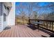 Sunny deck boasts a railing with space for outdoor table overlooking the trees at 52 Newman Dr, Villa Rica, GA 30180