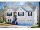 Charming two-story home with a two-car garage and an inviting front porch with American flag at 52 Newman Dr, Villa Rica, GA 30180