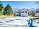 Well-maintained home featuring a long driveway and neatly kept lawn, surrounded by mature trees at 52 Newman Dr, Villa Rica, GA 30180