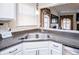 A view of the kitchen with a stainless steel sink and faucet, plus dark countertops and white cabinets at 52 Newman Dr, Villa Rica, GA 30180