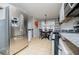 Spacious kitchen featuring stainless steel refrigerator, dining area, and ample cabinet space for storage at 52 Newman Dr, Villa Rica, GA 30180