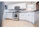 Bright kitchen featuring white cabinets, stainless steel appliances, and durable countertops for modern cooking at 52 Newman Dr, Villa Rica, GA 30180