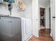 Practical laundry room with modern washer and dryer, and storage shelves at 52 Newman Dr, Villa Rica, GA 30180