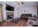 Cozy living room showcasing stone fireplace, french doors, and vaulted ceiling with fan at 52 Newman Dr, Villa Rica, GA 30180