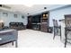 Cozy living room features a modern sofa, built-in shelving, bar and tile flooring at 52 Newman Dr, Villa Rica, GA 30180