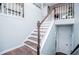 Elegant staircase featuring wood and white finishes leading to the upper level at 52 Newman Dr, Villa Rica, GA 30180