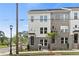 Modern townhome featuring brick and white siding, large windows, and manicured landscaping for an inviting curb appeal at 2581 Astaire Ct, Atlanta, GA 30318