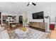 Open-concept living area with a modern TV, dining table, and kitchen island, perfect for entertaining and Gathering living at 2581 Astaire Ct, Atlanta, GA 30318