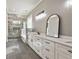 Modern bathroom featuring marble walk-in shower, separate vanities, and neutral color palette at 5241 Moon Rd, Powder Springs, GA 30127