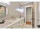 Bright bathroom featuring double sinks, marble countertops, and matte black fixtures at 5241 Moon Rd, Powder Springs, GA 30127