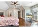 Bedroom with wood floors, tv, and doorways leading to closets and bathrooms at 5241 Moon Rd, Powder Springs, GA 30127