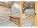Bedroom with wood paneling and sloped ceiling and wooden bed frame at 5241 Moon Rd, Powder Springs, GA 30127