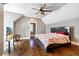 Cozy bedroom featuring hardwood floors, a ceiling fan, and a comfortable-looking bed, creating an inviting space at 5241 Moon Rd, Powder Springs, GA 30127