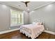 Cozy bedroom with hardwood floors, neutral paint, and great window view of the exterior at 5241 Moon Rd, Powder Springs, GA 30127
