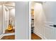 Hallway featuring storage shelves and an acoustic guitar, adding character and practicality to the space at 5241 Moon Rd, Powder Springs, GA 30127