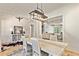 Bright dining room featuring modern chandelier, gray chairs, and beautiful wood floors at 5241 Moon Rd, Powder Springs, GA 30127