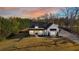 Beautiful modern farmhouse with black accents, a covered porch, and professionally landscaped front yard at 5241 Moon Rd, Powder Springs, GA 30127
