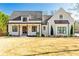 This home features a covered porch, professional landscaping, and double-hung windows at 5241 Moon Rd, Powder Springs, GA 30127