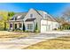 Exterior view of a home with a covered porch, a long driveway, and lush landscaping at 5241 Moon Rd, Powder Springs, GA 30127