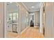 Hallway leading to kitchen with stainless steel appliances and hardwood floors at 5241 Moon Rd, Powder Springs, GA 30127