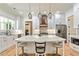 Bright kitchen featuring a large island with quartz countertop, stainless appliances, and pendant lighting at 5241 Moon Rd, Powder Springs, GA 30127