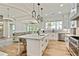 Bright kitchen with a large island, stainless steel appliances, and hardwood floors at 5241 Moon Rd, Powder Springs, GA 30127