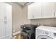Spacious laundry room with front load washer/dryer and ample storage cabinets at 5241 Moon Rd, Powder Springs, GA 30127