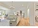Open concept living room with hardwood floors, chandelier, and sliding glass doors at 5241 Moon Rd, Powder Springs, GA 30127