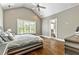Spacious main bedroom with vaulted ceilings, hardwood floors, and large window to let in natural light at 5241 Moon Rd, Powder Springs, GA 30127