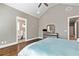 Bright main bedroom with hardwood floors, vaulted ceiling, and walk-in access to the bathroom at 5241 Moon Rd, Powder Springs, GA 30127