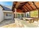 Covered outdoor patio area features stone countertops, a dining table, and a welcoming outdoor living space at 5241 Moon Rd, Powder Springs, GA 30127