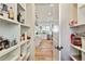 Charming walk-in pantry with custom shelving and easy access to the kitchen with white cabinetry and island at 5241 Moon Rd, Powder Springs, GA 30127