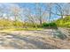 Gravel parking area surrounded by a wood fence offers plenty of parking spaces at 5241 Moon Rd, Powder Springs, GA 30127