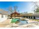 Backyard swimming pool with spa and covered seating area for relaxation and enjoyment at 5241 Moon Rd, Powder Springs, GA 30127