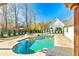 Inviting backyard swimming pool and spa with beautiful landscaping, perfect for leisure at 5241 Moon Rd, Powder Springs, GA 30127
