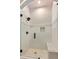 Elegant walk-in shower features subway tile, river rock accents, and frameless glass enclosure at 5241 Moon Rd, Powder Springs, GA 30127