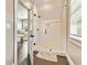 Walk-in shower features a glass door, tiled walls, and a contrasting mosaic accent, offering a modern spa-like experience at 5241 Moon Rd, Powder Springs, GA 30127