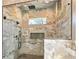 Luxurious walk-in shower with marble tiling, rainfall shower head, and modern fixtures at 5241 Moon Rd, Powder Springs, GA 30127