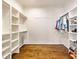 Spacious walk-in closet with custom shelving and rod system for optimal storage and organization at 5241 Moon Rd, Powder Springs, GA 30127