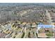 Aerial view of home nestled in a neighborhood surrounded by lush trees and greenery at 6040 Boulder Bluff Dr, Cumming, GA 30040