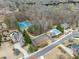 Aerial view of neighborhood featuring tennis courts, pool, and mature landscaping at 6040 Boulder Bluff Dr, Cumming, GA 30040
