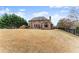 Expansive backyard with a play structure, patio, and mature trees offers a private retreat at 6040 Boulder Bluff Dr, Cumming, GA 30040