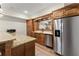 Basement kitchen bar area, featuring stainless steel fridge and granite countertops at 6040 Boulder Bluff Dr, Cumming, GA 30040