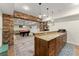 Basement bar area featuring granite countertops, stainless steel appliances, and brick accent decor at 6040 Boulder Bluff Dr, Cumming, GA 30040