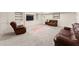 Finished basement features custom built-ins, comfortable leather seating, and neutral carpet at 6040 Boulder Bluff Dr, Cumming, GA 30040