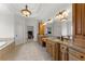 Luxurious bathroom with dual vanity, granite countertops, and custom cabinetry providing ample storage at 6040 Boulder Bluff Dr, Cumming, GA 30040