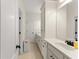 Bright bathroom with white cabinetry, double vanity, and tile flooring at 6040 Boulder Bluff Dr, Cumming, GA 30040