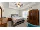 Cozy bedroom with large window and natural light, hardwood furniture, and patterned bedding at 6040 Boulder Bluff Dr, Cumming, GA 30040