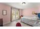 Bright bedroom featuring a private door, carpeted flooring, and lots of natural light at 6040 Boulder Bluff Dr, Cumming, GA 30040