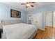 Comfortable bedroom with light blue walls, hardwood floors, neutral furniture, and closet access at 6040 Boulder Bluff Dr, Cumming, GA 30040